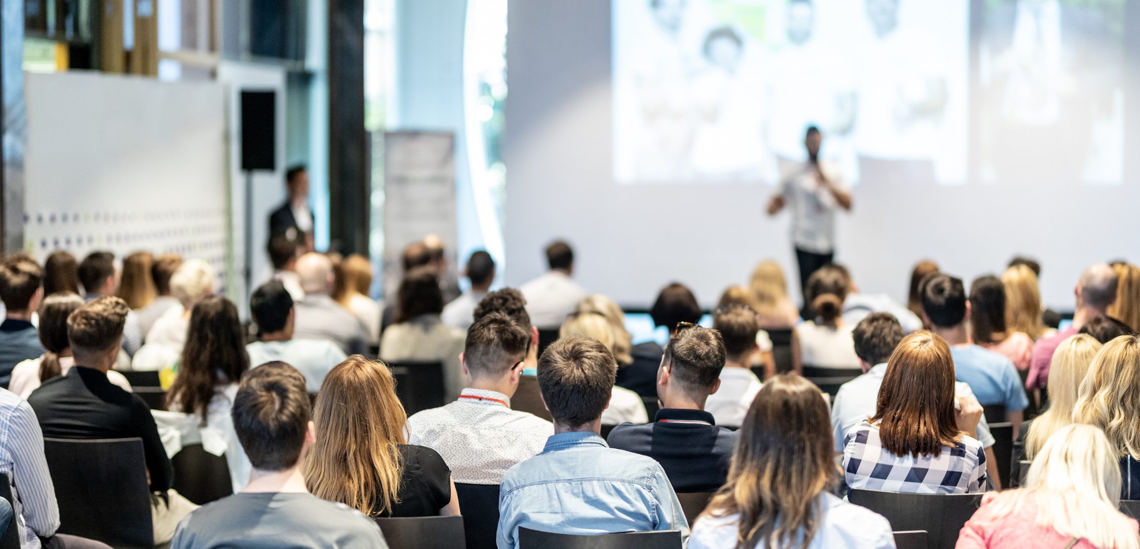 Audience Listening to a Speaker on the Stage